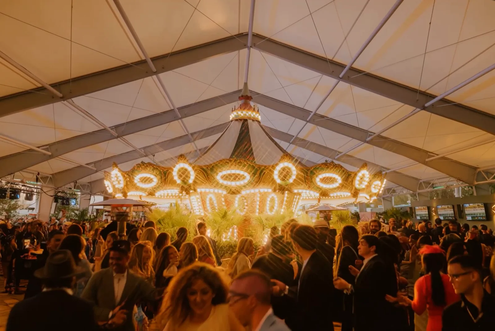 Carousel Club crowd beneath a warm chandelier. AI-assisted creative production.