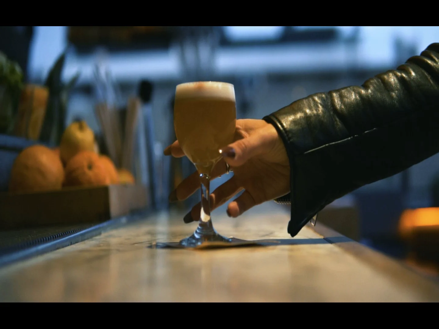 A cocktail held across the bar in the Ketner EX film.